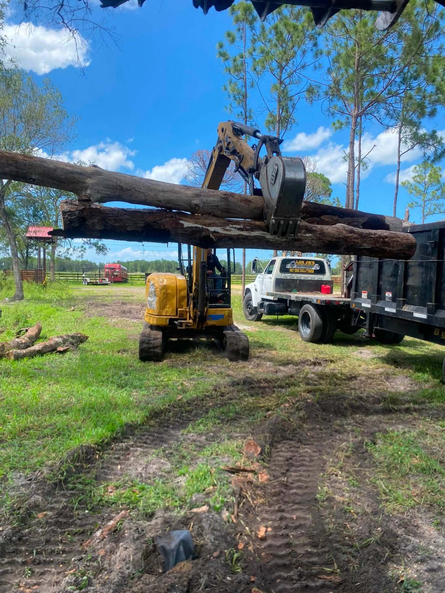 Los Jr's crew loading logs with excavator